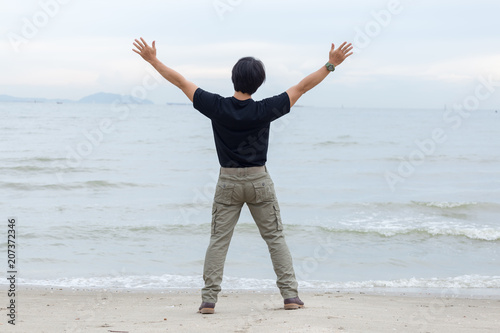 Guy wearing cargo pants and standing on the beach