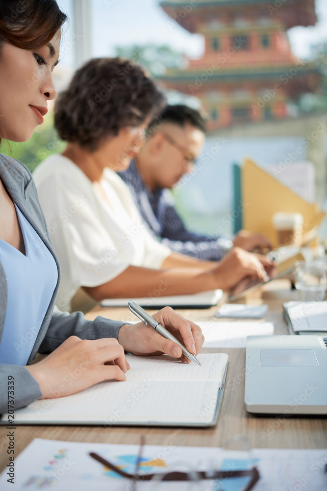 Woman writing business plan Woman writing business plan