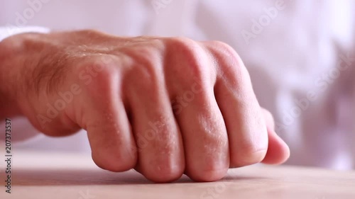 Male hand beating on table