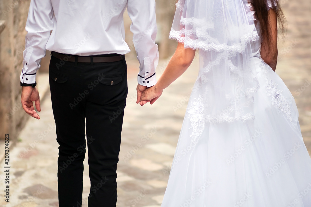 Wedding couple. Bride and groom holding hands Wedding couple. Bride and groom holding hands