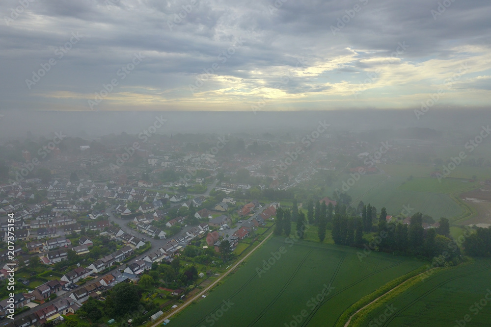 Aerial view of a city under a morning mist