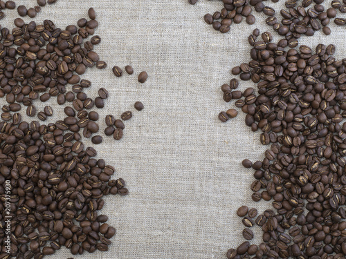 roasted coffee beans on a kitchen table. © homohomozaza