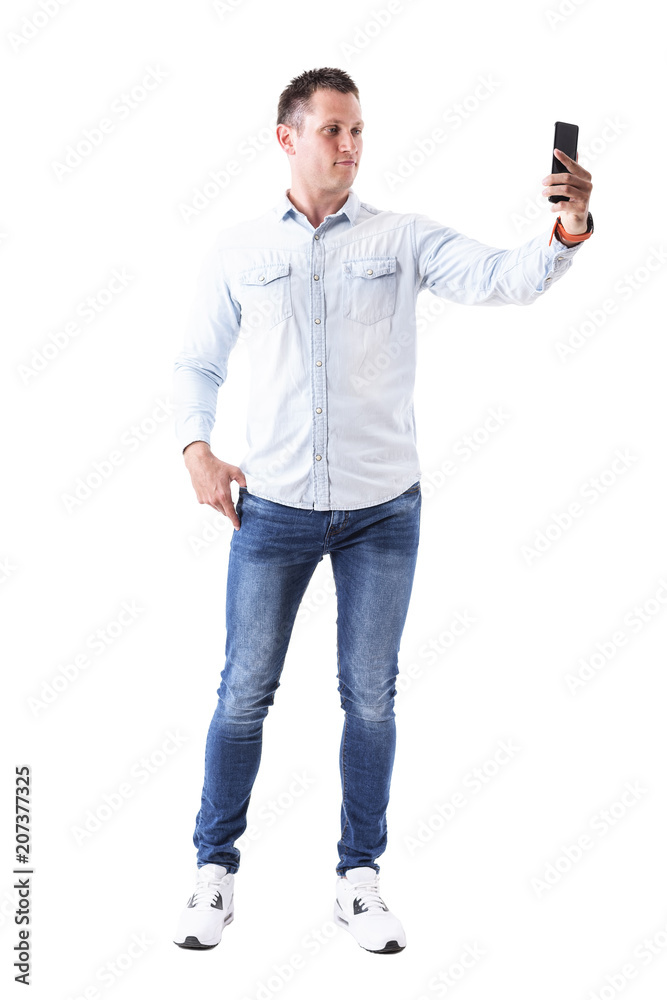 Serious adult elegant caucasian male fashion model taking picture with mobile phone. Full body isolated on white background. Serious adult elegant caucasian male fashion model taking picture with mobile phone. Full body isolated on white background.