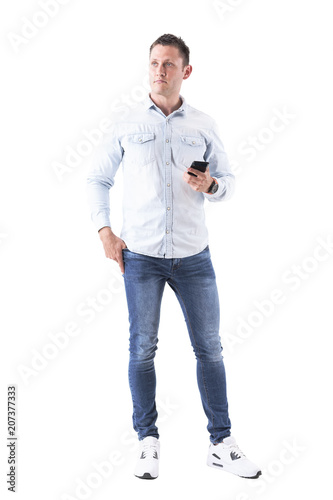 Adult caucasian elegant thinking business man holding mobile phone and looking away. Full body isolated on white background. 