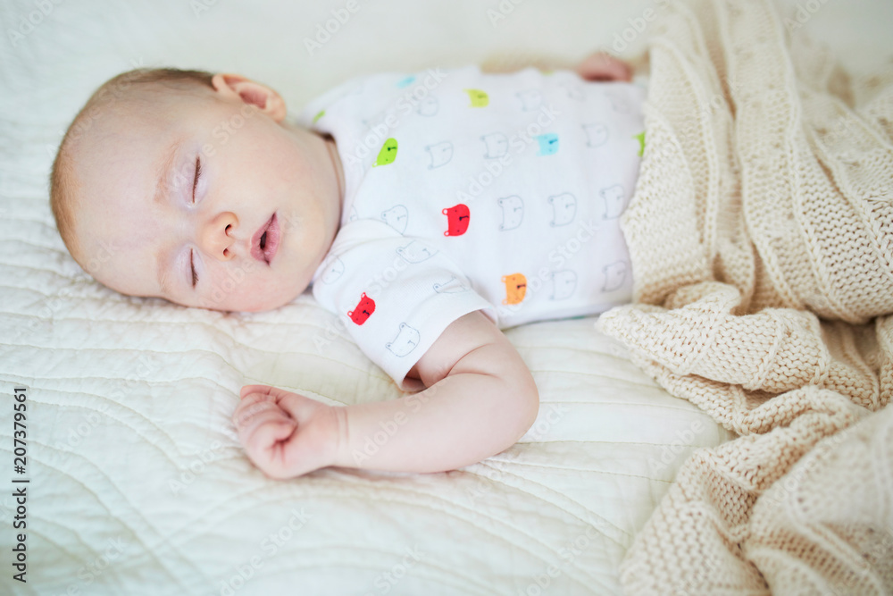 3 months old baby girl sleeping under knitted blanket 3 months old baby girl sleeping under knitted blanket