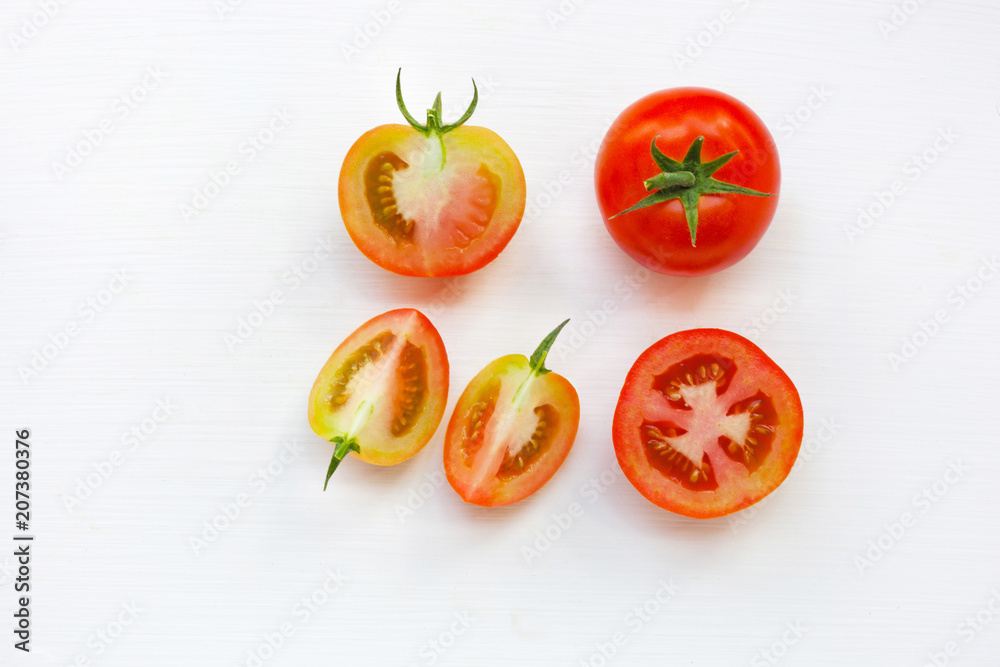 Fototapeta premium Fresh tomatoes on white wooden background.