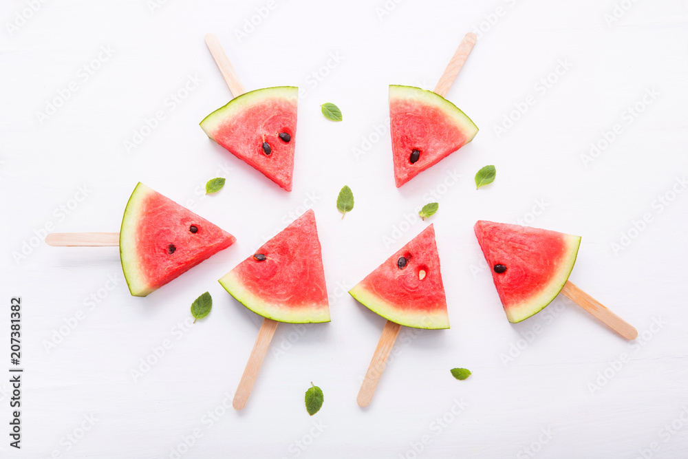 Watermelon slice popsicles on white background