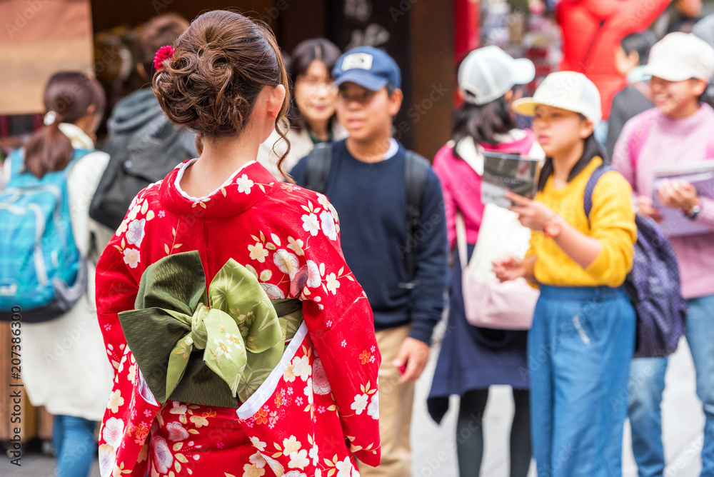 TOKYO, JAPAN - OCTOBER 31, 2017: The girl in a kimono on a city street. Back view. Close-up.