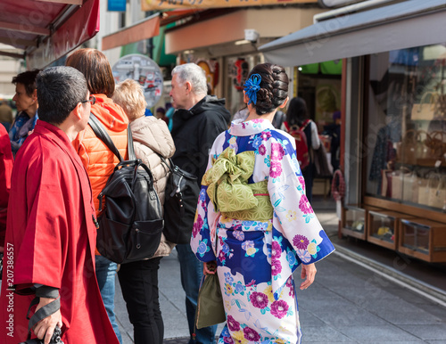 TOKYO, JAPAN - OCTOBER 31, 2017: People on a city street. Copy space for text. Back view.