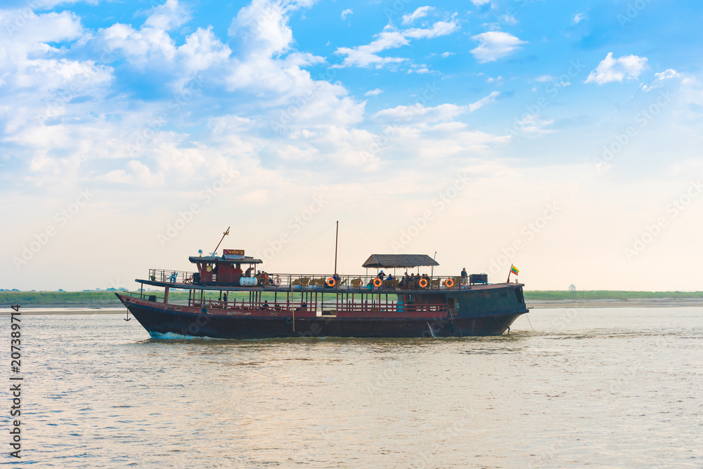 MANDALAY, MYANMAR - DECEMBER 1, 2016: Tourist boat on the river Irrawaddy, Burma. Copy space for text.