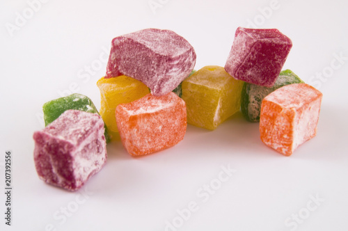 Pieces of sweet multi-colored lakuma on a light background