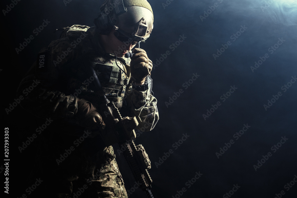 Fototapeta premium Special forces soldier with rifle on dark background