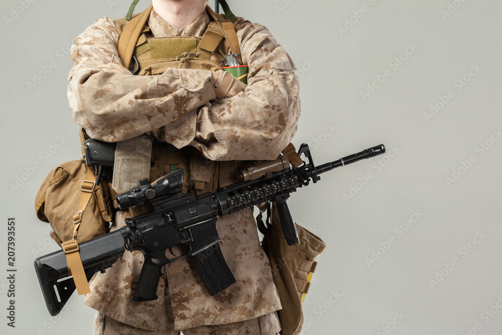 Soldier in camouflage holding rifle Soldier in camouflage holding rifle