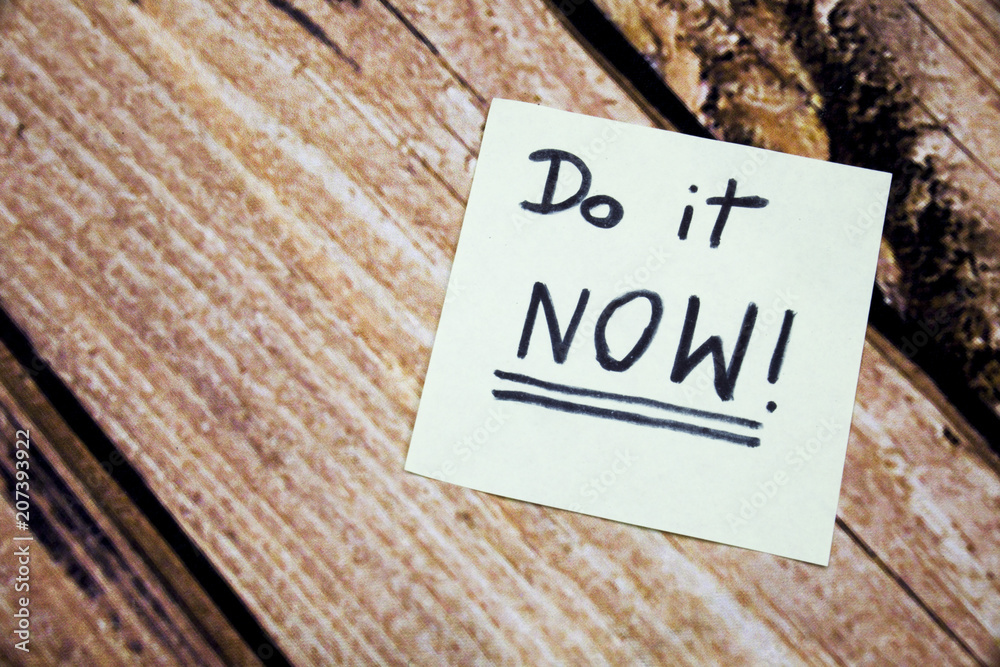 Do it now conceptual handwritten message on the white paper. Business ...