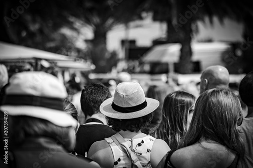 Hat in the crowd, back, black and white