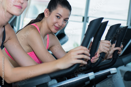 Group of woman using a bicycle in fitness center