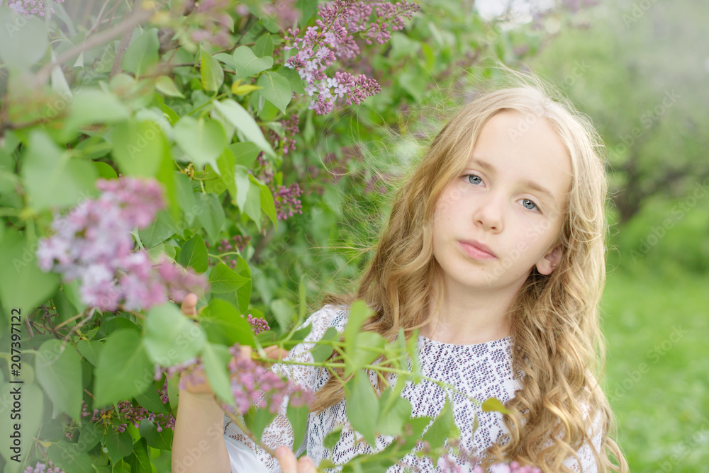 blonde hair girl in a blooming lilac garden blonde hair girl in a blooming lilac garden