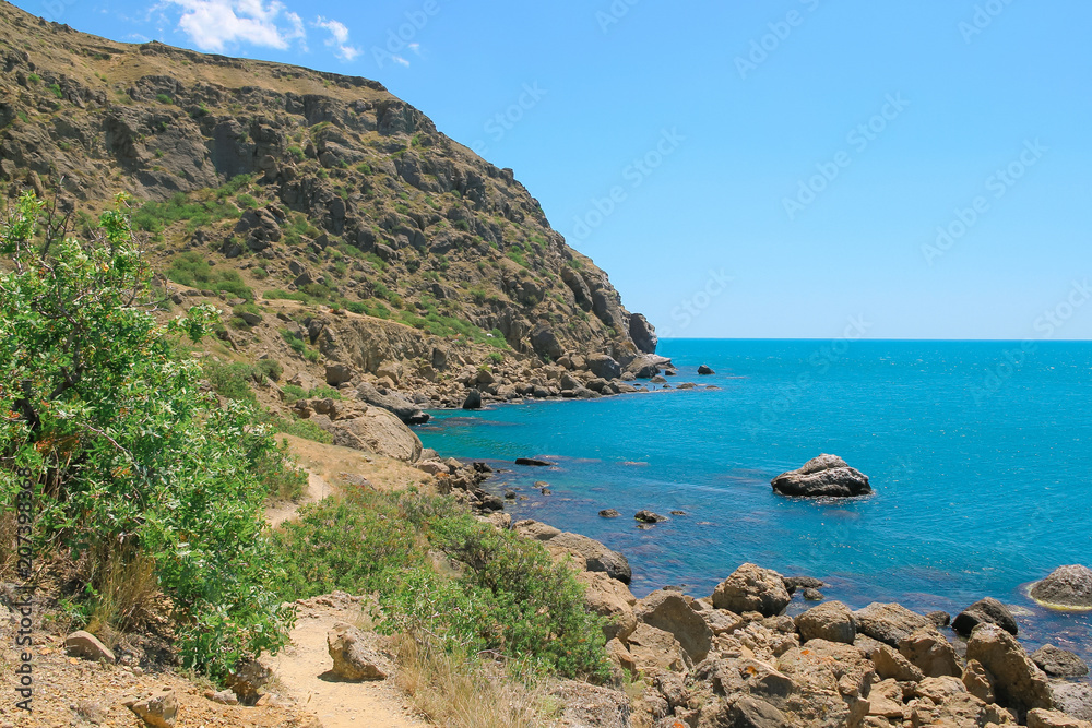 Sea and rocks landscape at Cape Meganom, the east coast of the peninsula of Crimea. Colorful background. Travelling concept. Copy space.