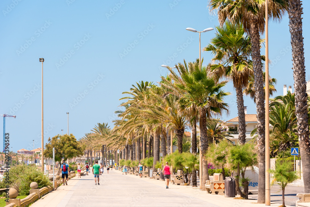 Naklejka premium SITGES, CATALUNYA, SPAIN - JUNE 20, 2017: View of the embankment. Copy space for text.