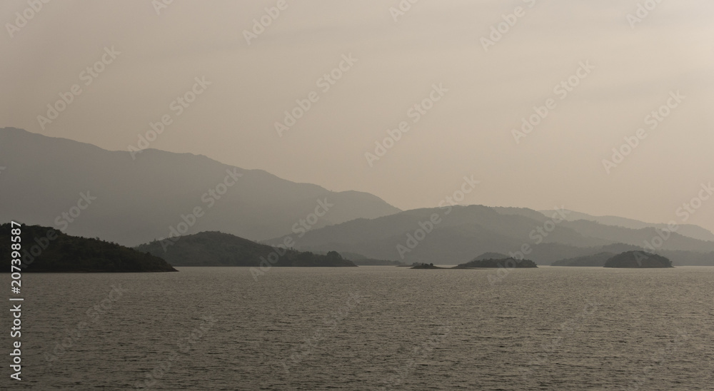 Bhadra backwaters with beautiful moutainscapes with morning mist covered on it.