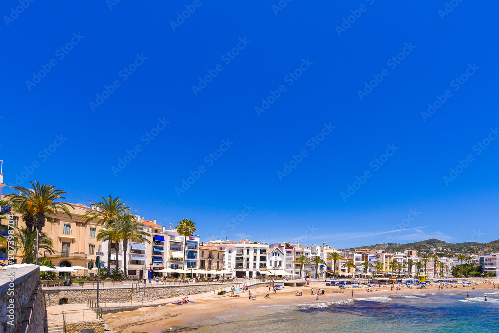 SITGES, CATALUNYA, SPAIN - JUNE 20, 2017: View of the sandy beach and promenade. Copy space for text.