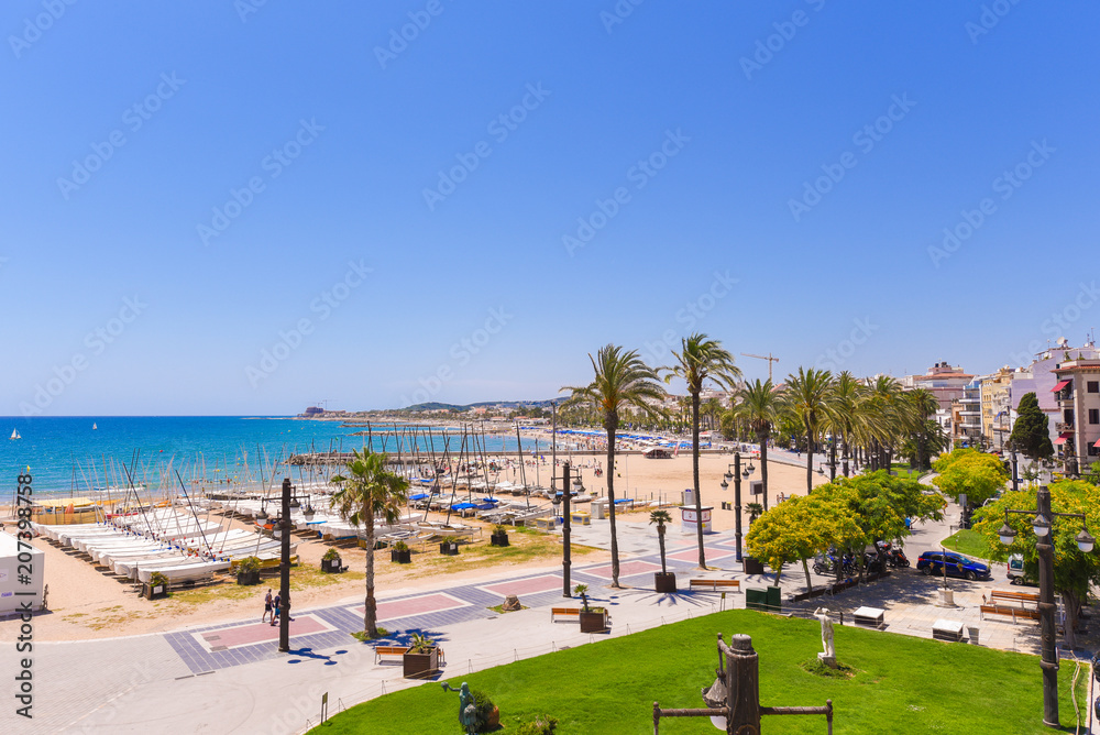 SITGES, CATALUNYA, SPAIN - JUNE 20, 2017: View over the promenade and the beach. Copy space for text.