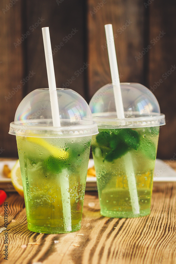 fresh mint lemonade - cold drink (a plastic glass of drink) - mojito Stock  Photo | Adobe Stock