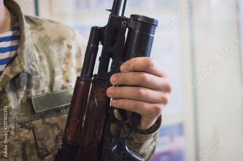 sub machine gun on the table in the interior gunsmith. photo