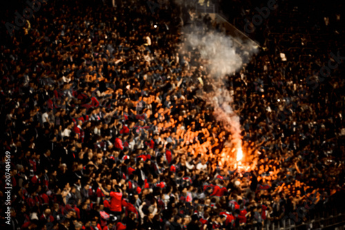Naked football fans cheer their soccer team score goal with the fire at the stadium