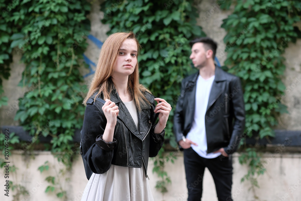 Beautiful red haired girl and brunette guy posing together Beautiful red haired girl and brunette guy posing together