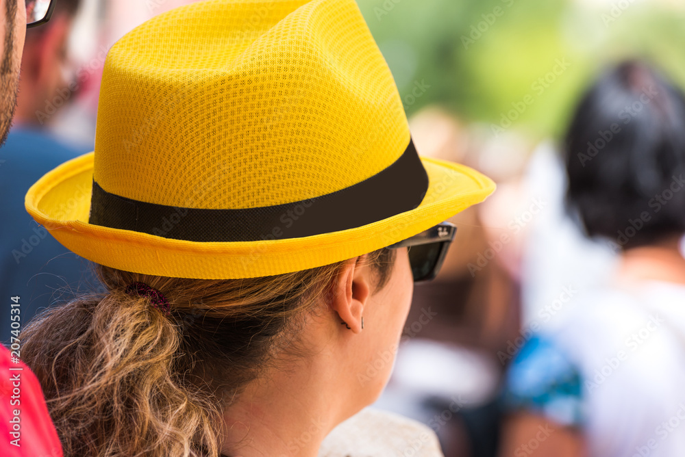 TARRAGONA, SPAIN - SEPTEMBER 17, 2017: Woman in a yellow hat. Close-up. TARRAGONA, SPAIN - SEPTEMBER 17, 2017: Woman in a yellow hat. Close-up.