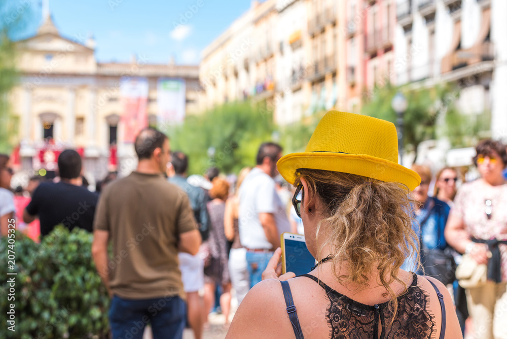 TARRAGONA, SPAIN - SEPTEMBER 17, 2017: Woman in a yellow hat on holiday Santa Tecla. Copy space for text.
