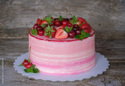 beautiful homemade cake with cherries and strawberries