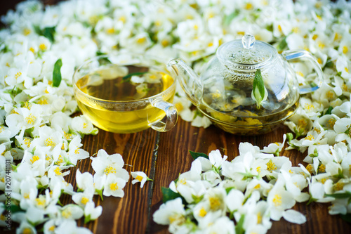 Tea with jasmine flowers in a glass teapot