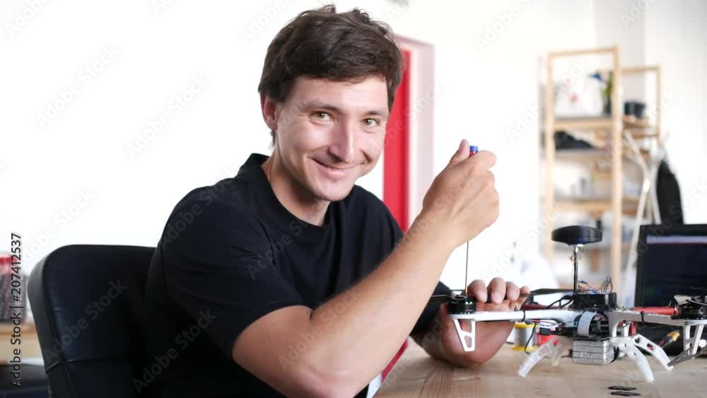Portrait ofa technician fixing drone.