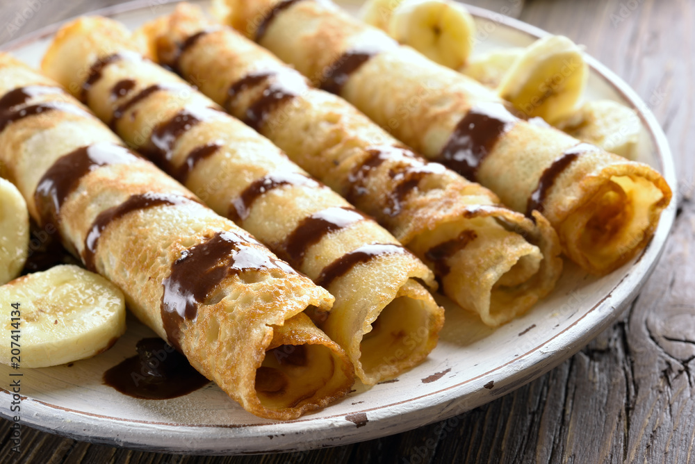Delicious crepe roll with banana slices Delicious crepe roll with banana slices