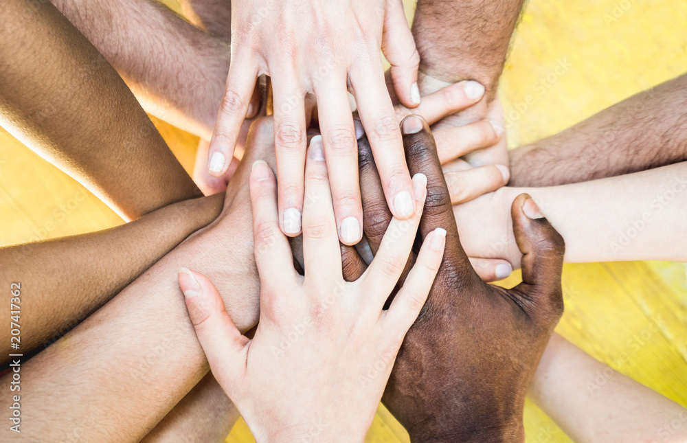 Top view of multiracial stacking hands - International friendship concept with multiethnic people representing peace and unity against racism - Multi racial love and integration between diversity - obrazy, fototapety, plakaty 