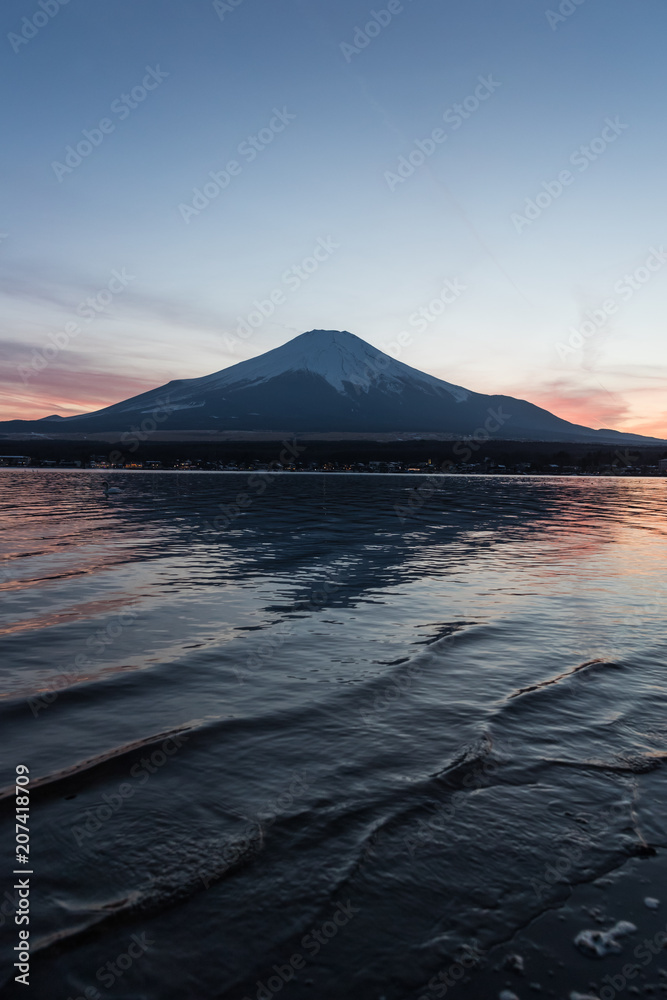 View of Mount Fuji and Lake Yamanakako in winter evening. Lake Yamanakako is the largest of the Fuji Five Lakes.