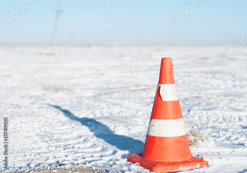 Orange traffic cone used for traffic warning and control.