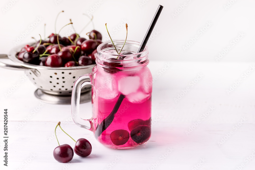 Cold Drink with Cherry in Jars on White Wooden Background Cold Detox Infused Water Summer Drink Copy Space Cold Drink with Cherry in Jars on White Wooden Background Cold Detox Infused Water Summer Drink Copy Space