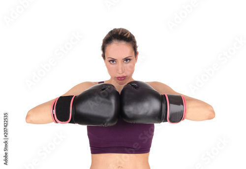 Woman with boxing gloves looking, smiling