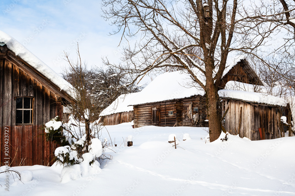 snowy yard in abandoned russian village in winter