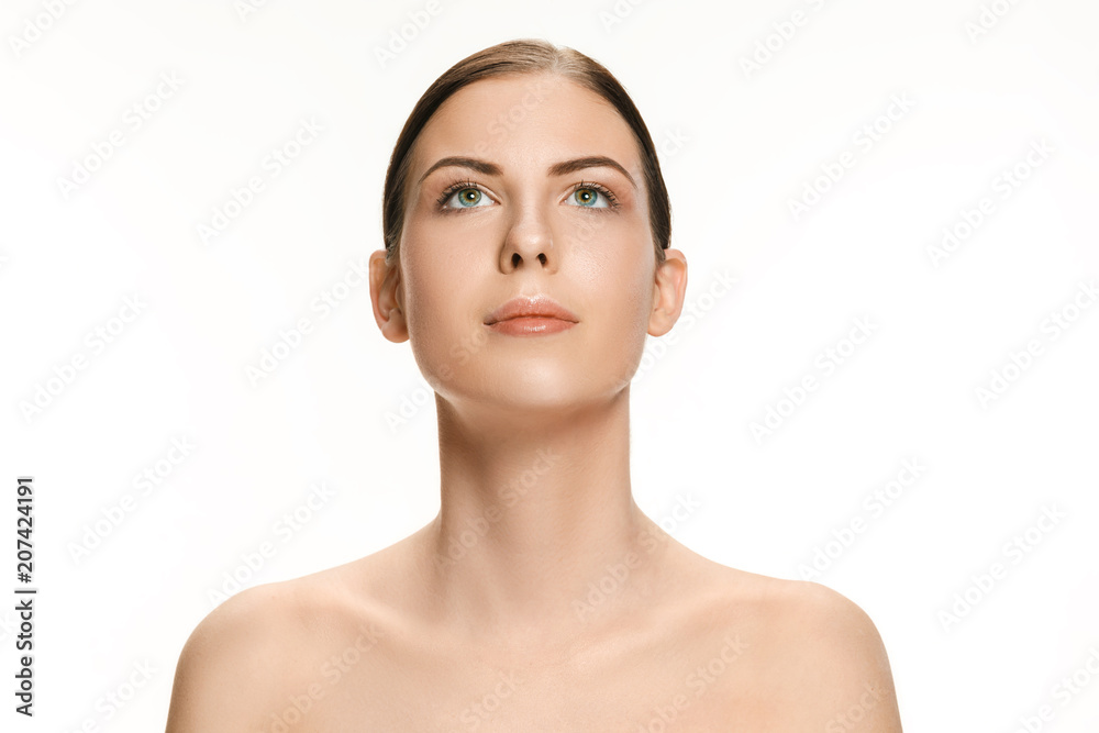 Beautiful face of young adult woman with clean fresh skin isolated on white Beautiful face of young adult woman with clean fresh skin isolated on white