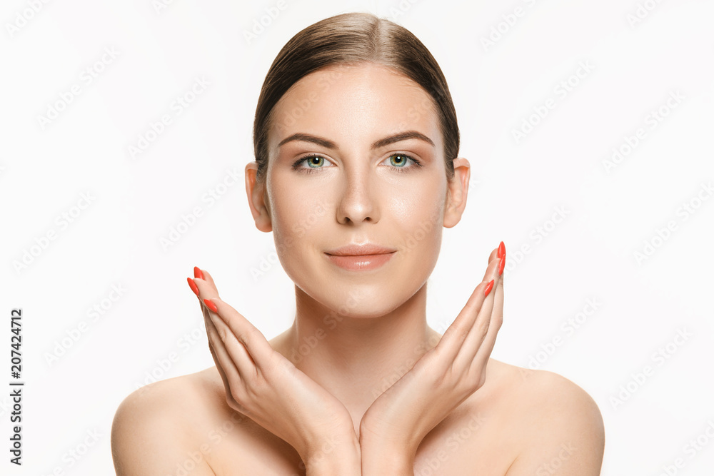 Beautiful face of young adult woman with clean fresh skin isolated on white Beautiful face of young adult woman with clean fresh skin isolated on white