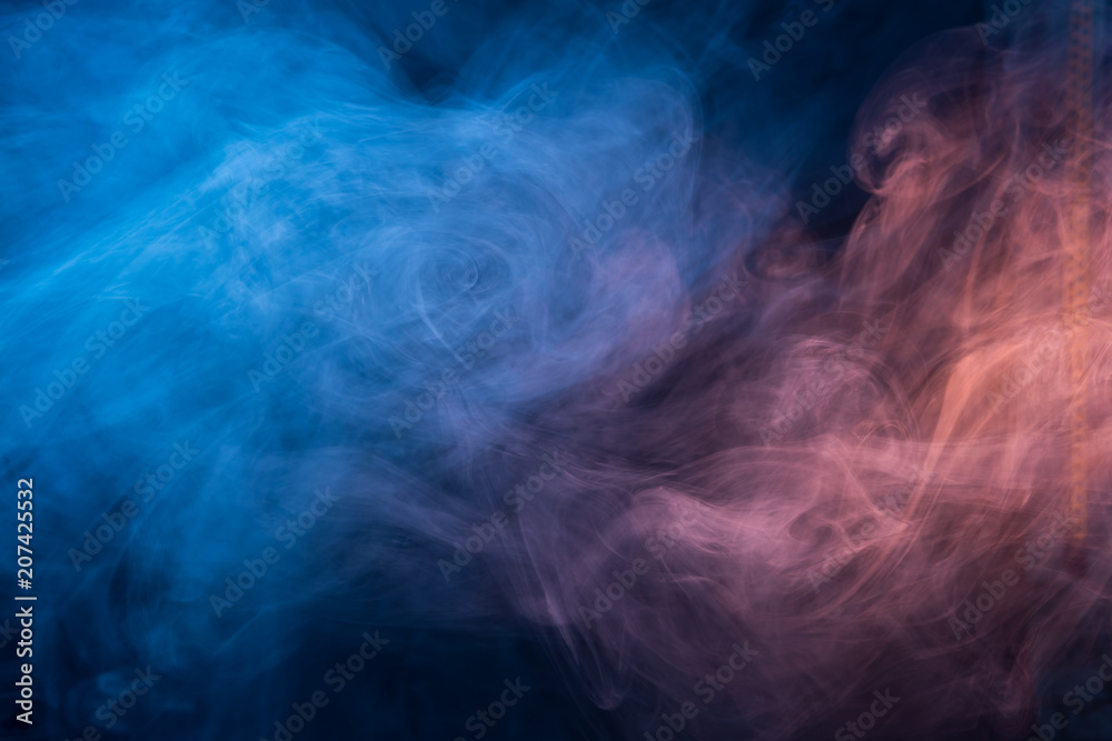 Abstract blue and pink smoke on a dark background