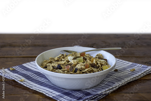 A bowl full of muesli cereals with spoon