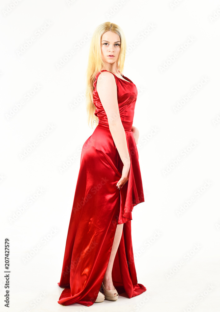 Lady rented fashionable dress for visiting event. Dress rent service, fashion industry. Girl blonde posing in dress. Dress rent concept. Woman wears elegant evening red dress, white background.
