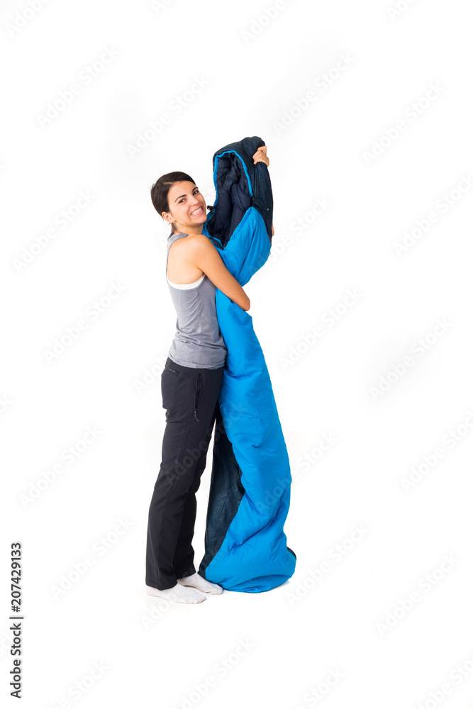 Happy woman holding sleeping bag Happy woman holding sleeping bag
