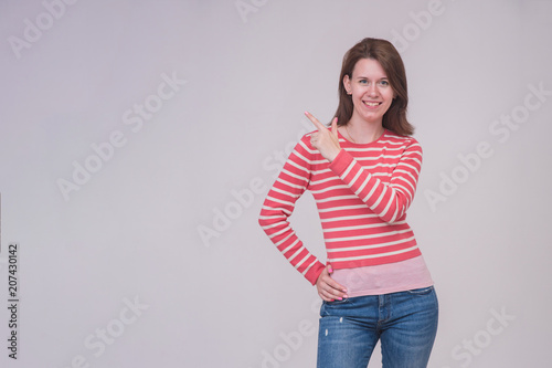 portrait of a beautiful brunette girl on a white background in different poses showing a product