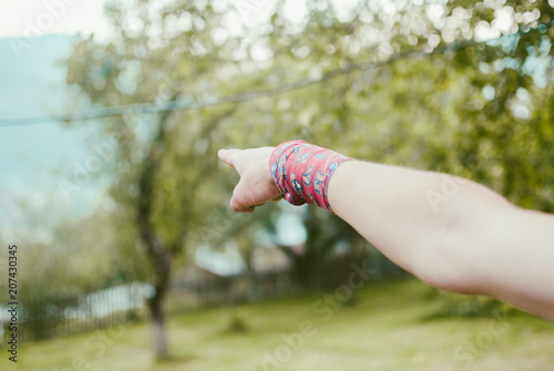 Pale man's hand pointing something over the landscape during the journey in the Carpathian mountains, Ukraine